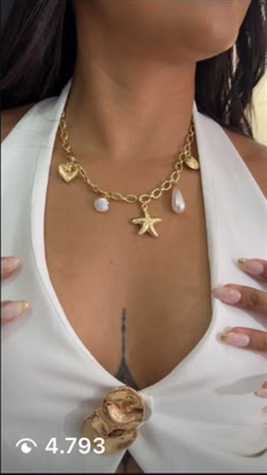 Reel de ISOLÉ con collar dorado y top blanco